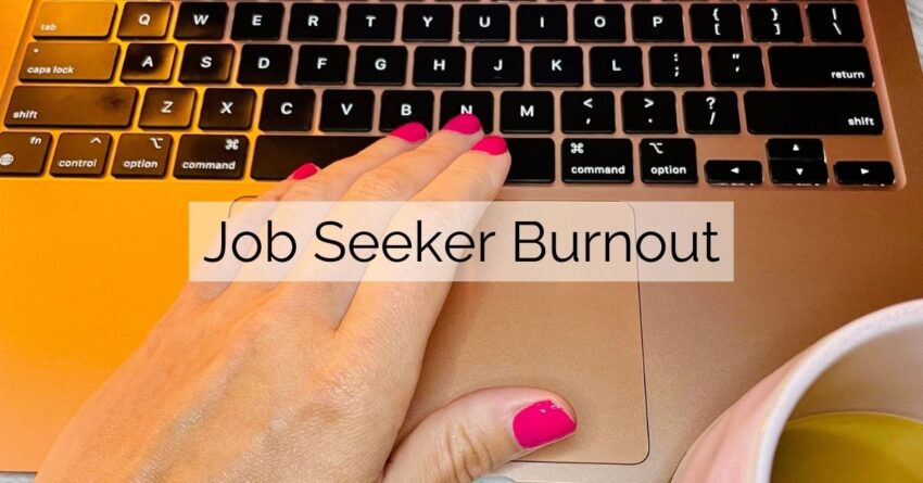 manicured nails on a woman's hand hover over the keyboard of a macbook air with a coffee cup nearby